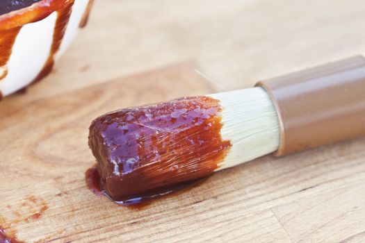 Barbecue sauce and brush. Shallow DOF. 