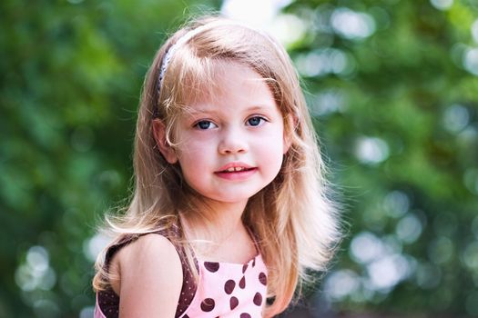 Portrait of a little girl smiling at the camera.