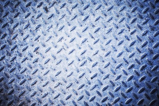 metal texture background of a grid and grate pattern with a blue hue to the metal 