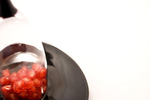 Seeds grenade on a plate inside the wineglass
