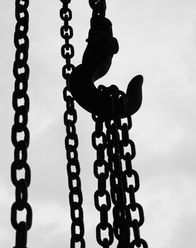 chain suspended in air over lighter background