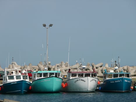 Row of cute little fishing boats.