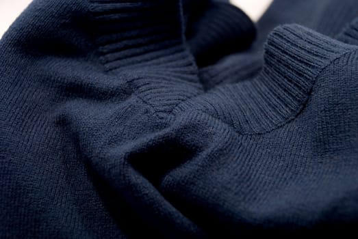 The blue sweater folded on the table
