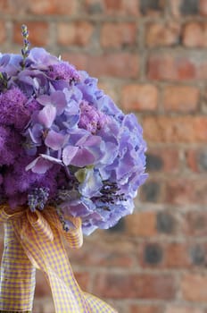 A colorful purple bridal bouquet of flowers