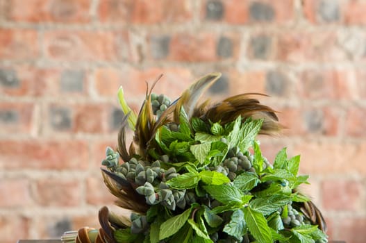 A colorful purple bridal bouquet of flowers with mint leaves