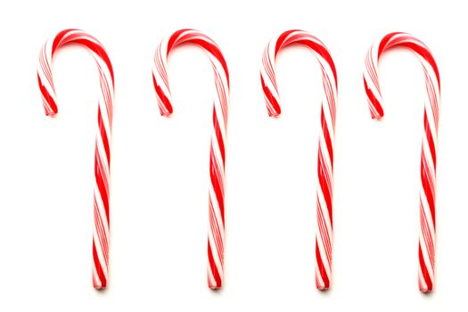 Four red and white Christmas candy canes isolated on white