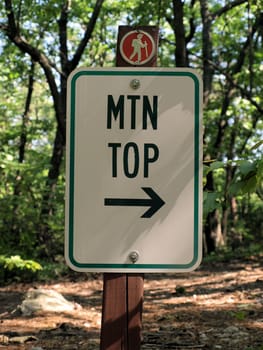 trail sign pointing to the top of the mountain