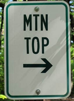 trail sign pointing to the top of the mountain