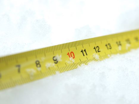 Measuring tape on a snow in the winter         