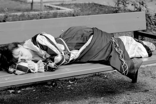 girl in medieval dress lying on a bench
