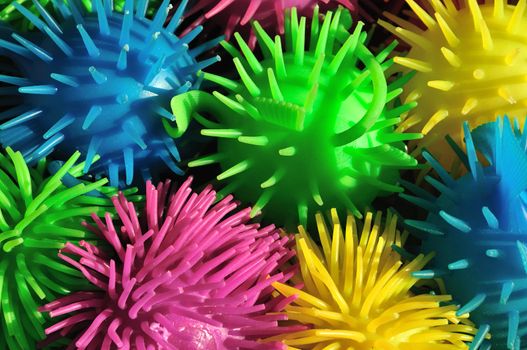 Background of colorful soft spiny rubber fish toys