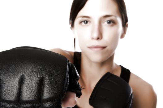 An image of a woman in gym clothes, with boxing gloves, strength and fitness
