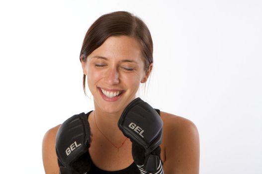 An image of a woman in gym clothes, with boxing gloves, strength and fitness