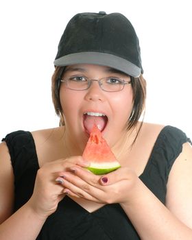 A young preteen girl is eating a slice of watermelon, isolated against a white background.