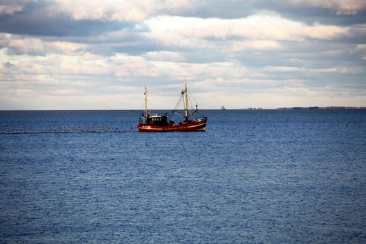 A fishing boat at dawn on the sea