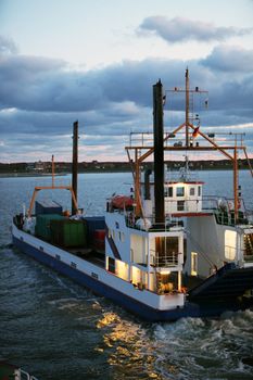 A fishing boat at dawn on the sea