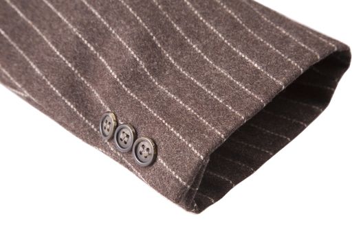 closeup of suit, detail of brown cuff on white background
