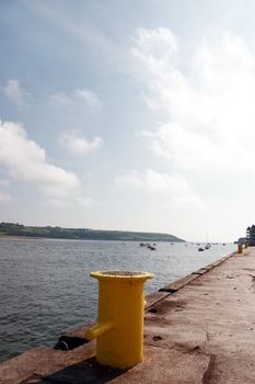 a yellow bollard on an irish quay