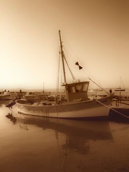 image of a fishing boat in a mediterranean port