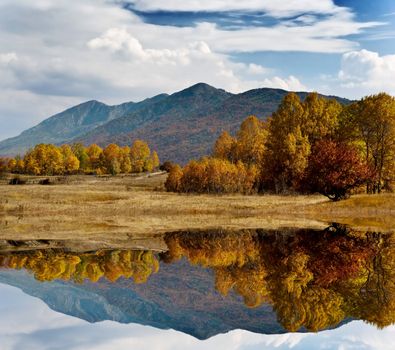 autemn country side landscape with mountains and clouds