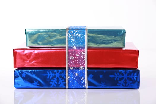 Three shiny colorful Christmas presents