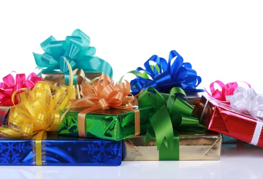 Colorful Christmas presents stacked together on white