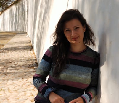 pretty brunette female against white wall