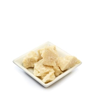 small container with parmesan on a white background