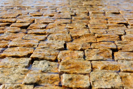 block pavemen covered with film of flowing water