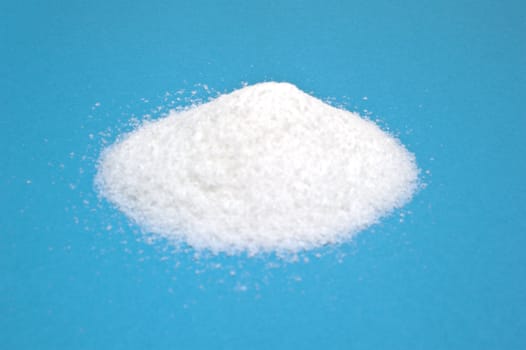 small amount of sugar on a blue background
