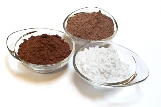 
cocoa cake and cocoa powder on a white background
