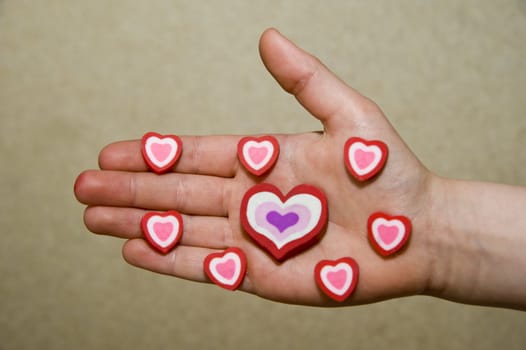 Beautiful symbolical hearts on a children's palm.