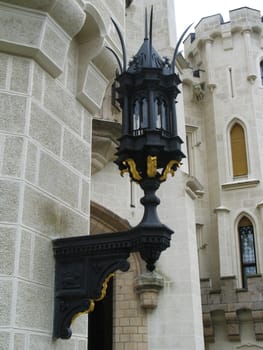 Old street lamp on the wall of ancient castle