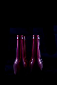 red beer bottles isolated on a black background