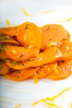 fresh  and healthy Honey glazed carrots on a plate with tyme on top