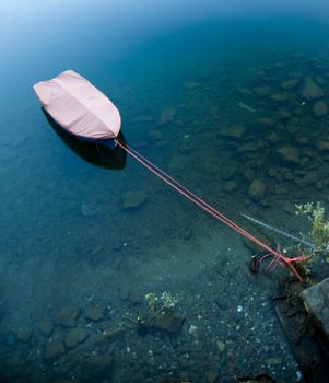 a small blu bloat moored in the lake