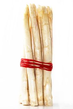 a bundle of white asparagus on white background