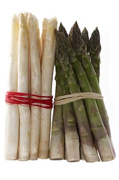 a bundle of green and a bundle of white asparagus  isolated on white background