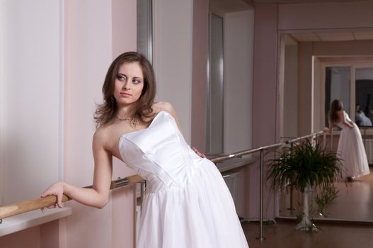 Girl in white wedding dress in dance studio