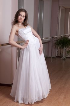 Girl in white wedding dress in dance studio