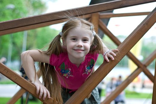 smiling little girl in a wooden structures