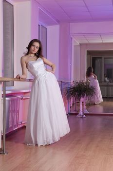 Girl in white wedding dress in dance studio