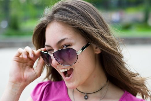 portrait of a smiling beautiful teenage girl in sunglasses