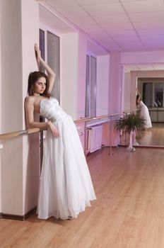 Girl in white wedding dress in dance studio