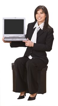 Smiling businesswoman presenting something to her notebook.Empty laptop screen to put there your content. 