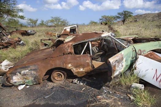 Old rusted car in junkyard.