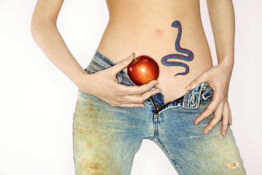 Portrait of attractive Caucasian young woman holding apple by snake tattoo on stomach.