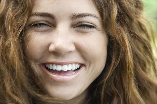 Young adult Caucasian female smiling and looking at viewer.