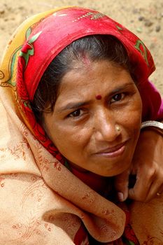 Woman wearing a beautifully embroidered sari - india