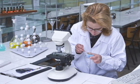 Woman researcher preparing samples for the microscope. 
